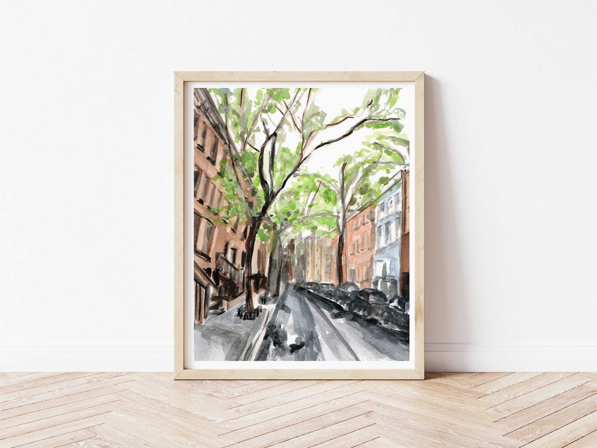 New York city streetscape print of painting by Medjool Studio. Print of original gouache painting that is a slightly abstract interpretation of the classic architecture. Shows a scene looking down a street with tall buildings, cars and trees along the sides of the street.